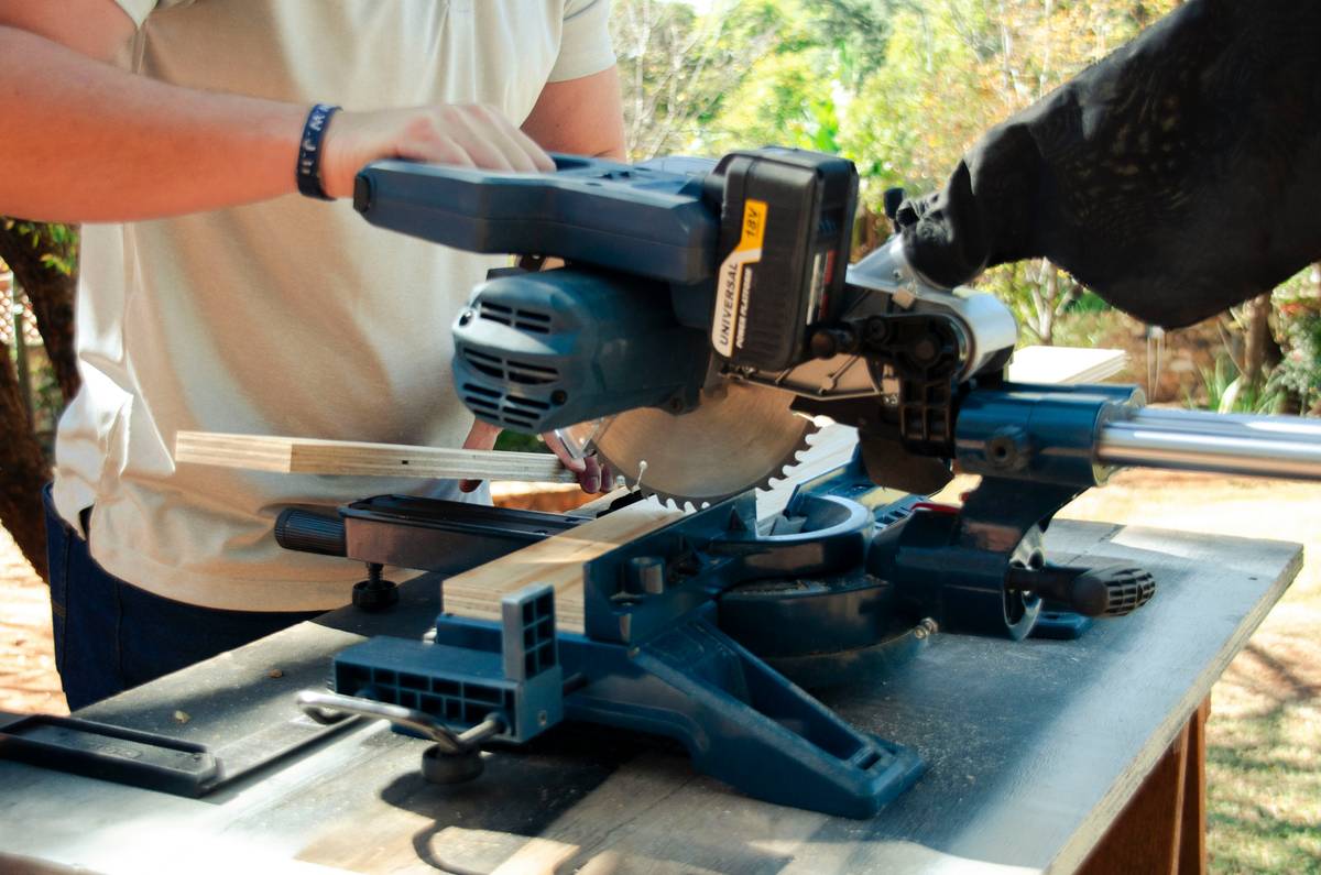 Side-by-side comparison chart showing key differences between consumer and industrial band saws for wood: frame material, motor HP, resaw capacity, guide type, and price range